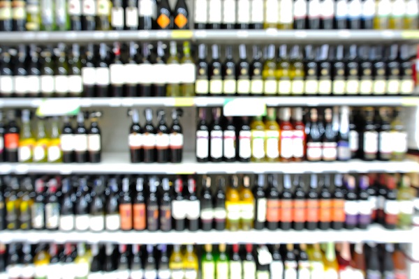 Abstract Blur or Defocus Background of Bottles of Wine on Shelf in Supermarket or Liquor store.